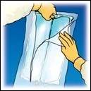 Two hands carefully hold and open a transparent plastic pouch containing a medical device against a blue background