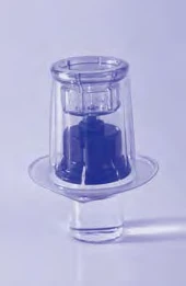 Small transparent glass vial with blue rubber stopper and circular base on a light monochromatic purple background