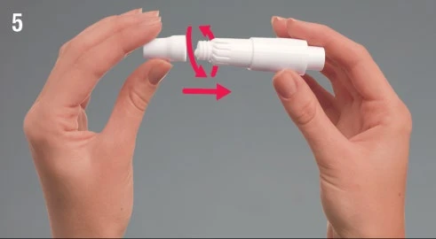 Two hands holding a white medical device rotating it clockwise as indicated by a curved red arrow and a straight arrow