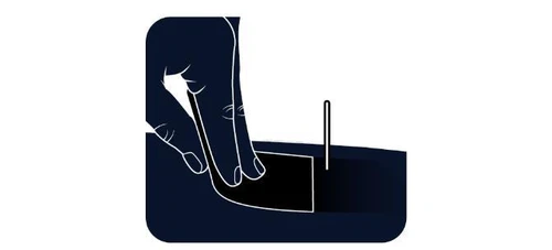 A black silhouette of a hand gently lifting the edge of an adhesive bandage applied to a flat surface next to a small vertical needle