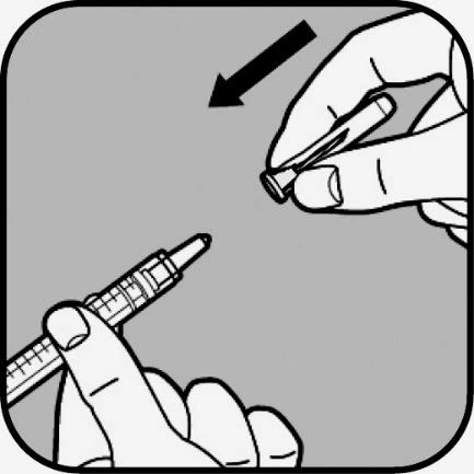 Two hands handling two syringes to prepare the injection