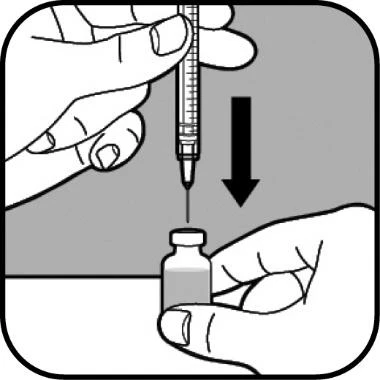 One hand holds a syringe vertically while the