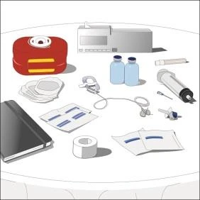 Medical devices on a white table including syringe, vials, adhesive bandage, documents, stethoscope, red container, and a black book