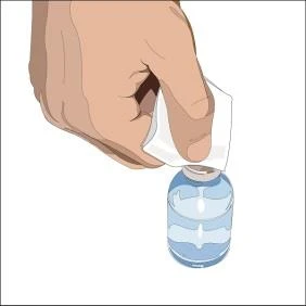 A hand using a white cloth to clean the rubber stopper of a glass vial containing a clear liquid