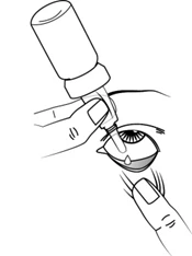 A hand holds a dropper above an open eye to administer a drop of medication directly onto the eye surface