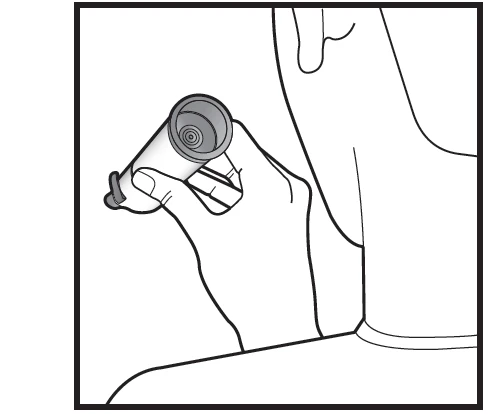 A hand holds a cylindrical inhaler pointing upward