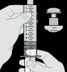 A hand holds a graduated syringe vertically marked from 1 to 12 while