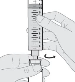 A hand holds a graduated syringe while