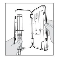 Two hands hold open a rigid case containing a ready-to-use syringe