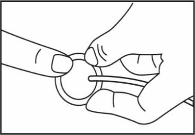Two hands hold and manipulate a small circular object with a thin horizontal rod passing through the center of the disc