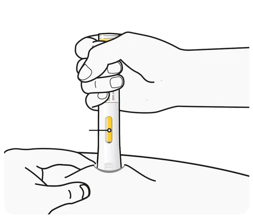 A hand holds a white injectable pen with yellow details and the tip placed on the skin of the