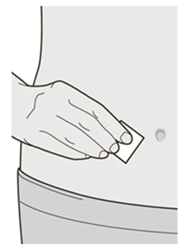 A hand applying a small square adhesive patch onto the skin of the