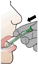 A gloved hand inserts a syringe containing clear liquid into the