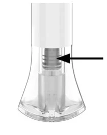 Detail of a transparent medical device with a black arrow indicating an internal gray striped cylindrical section