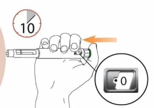 Una mano impugna una penna iniettiva con un timer che segna 10 secondi e un ingrandimento che mostra il display con il numero 0