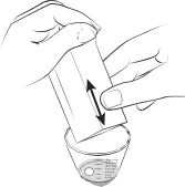 Two hands holding a rectangular container and moving it vertically up and down over a small circular container with internal markings