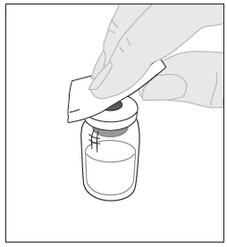 A hand holds a rubber disc over the stopper of a glass vial containing a white liquid