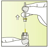 A hand holding a vial with needle while the