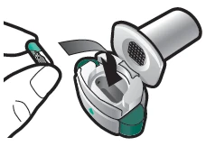 A hand lifting the white protective lid of a circular medical device with green details and a gray interior