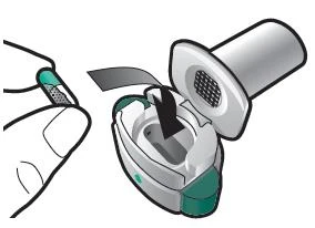 Illustration of a hand holding a white and green medical device with a protective cap being removed for use