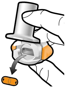 Ręka trzyma białe i pomarańczowe urządzenie medyczne ze strzałką czarną wskazującą ruch obrotowy w dół