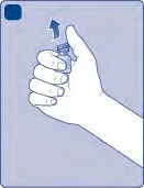 A hand holding a small glass vial pointing upward