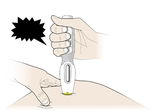 A hand holding a white medical device for the