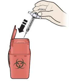 A hand holding a syringe and inserting it vertically into a red biohazard waste container with a biological hazard symbol