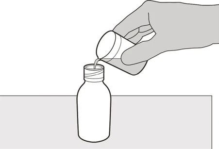 A hand pours the contents of a small white container into the