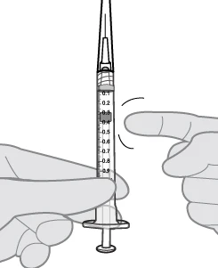Two hands holding a vertical syringe with a finger indicating the 0.3 ml mark on the graduated cylinder with numbers from 0.1 to 0.9