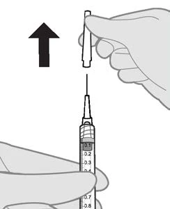 A hand holding a protective cap and lifting it upward