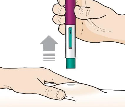 A hand holding vertically a purple and white auto-injector while activating it