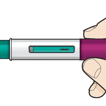 A hand holding horizontally a pen-shaped medical device with white body, central transparent window showing green liquid, and dosage indicator