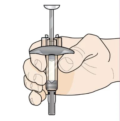 A hand holding vertically a transparent syringe with metallic plunger and cylindrical barrel against a white background