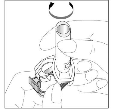 A hand holding a cylindrical medical device while the