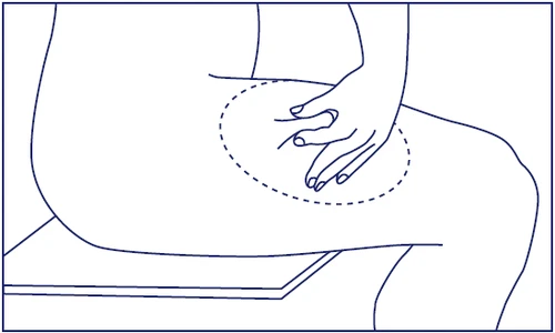 Line drawing of a seated person pointing with their hand to the thigh area delineated by a dashed circle