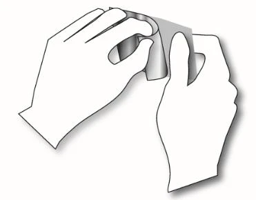 Two hands gently folding and rolling a sheet of paper or thin flexible material upon itself