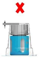 A large red cross above a transparent container with a blue base and a shaded gray lid on a white background