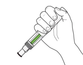 A hand firmly holds a vertical medical injection pen with a transparent reservoir containing green liquid