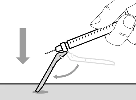 A hand holds a syringe tilted downward being pushed onto a medical device with an arrow indicating the downward movement