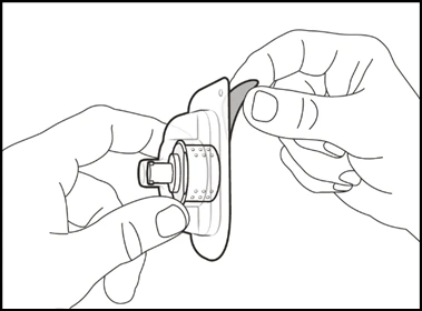 Two hands gently lifting and removing the adhesive base of a circular medical device with a small central connector