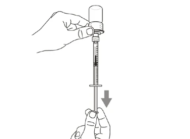 A hand holds a vial while the