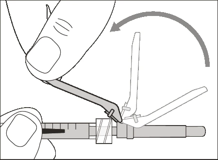 A hand rotates an opening device to detach the upper part of a horizontal syringe held by the
