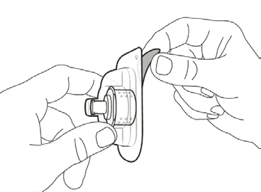 Two hands holding and separating components of a circular medical device with a flat base and a central cylindrical element