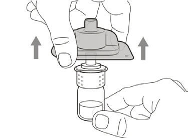 Two hands lifting a gray medical device upward toward the