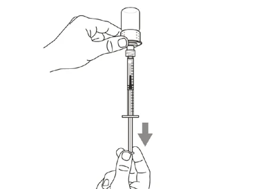 A hand holds a vial while the