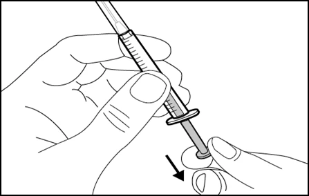 A hand holds a tilted syringe while the