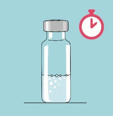 Transparent glass vial containing liquid and air bubbles