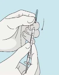 Two hands holding a syringe with a needle and a cap being removed downward as indicated by a black arrow on a blue background
