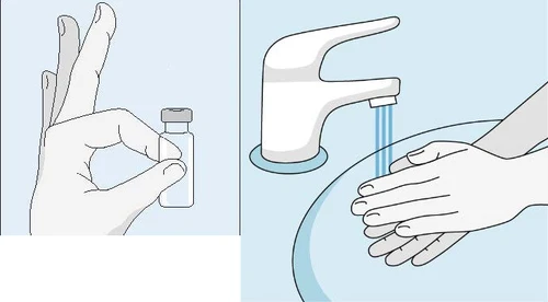 A gloved hand holds a glass vial next to a